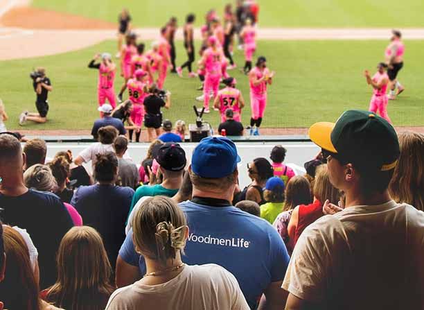 A WoodmenLife member attends a local baseball event with his community
