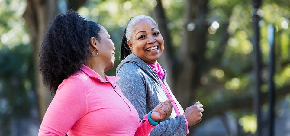 Two women in retirement walking outside for exercise
