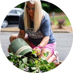 A woman plants flowers to spruce up the community
