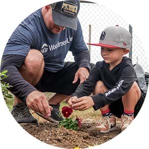A father and son plant flowers to spruce up the community