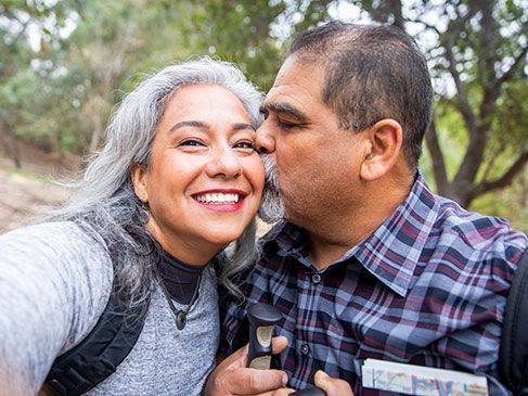 Retired Hispanic couple enjoying an outdoor hike.