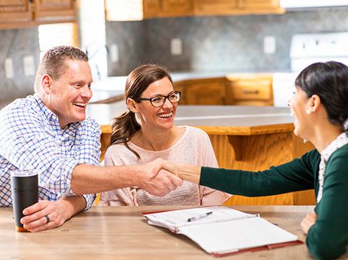 WoodmenLife representative discussing a couple's insurance needs.