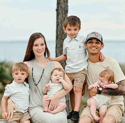 A happy family sitting together by the waterfront.