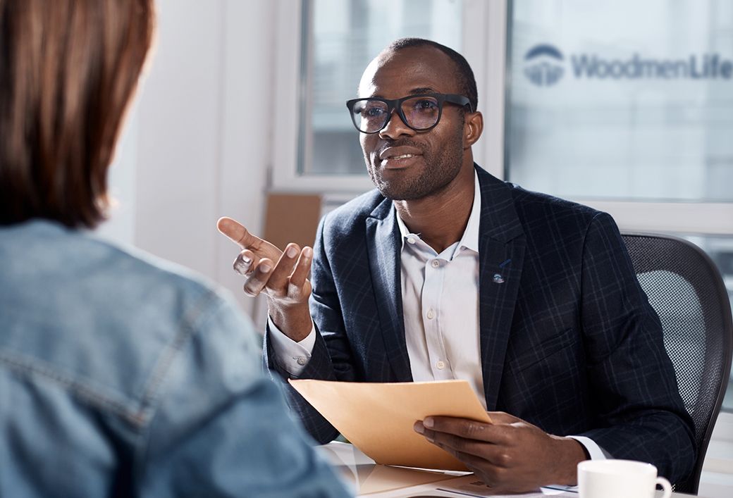 Two people having a desk conversation