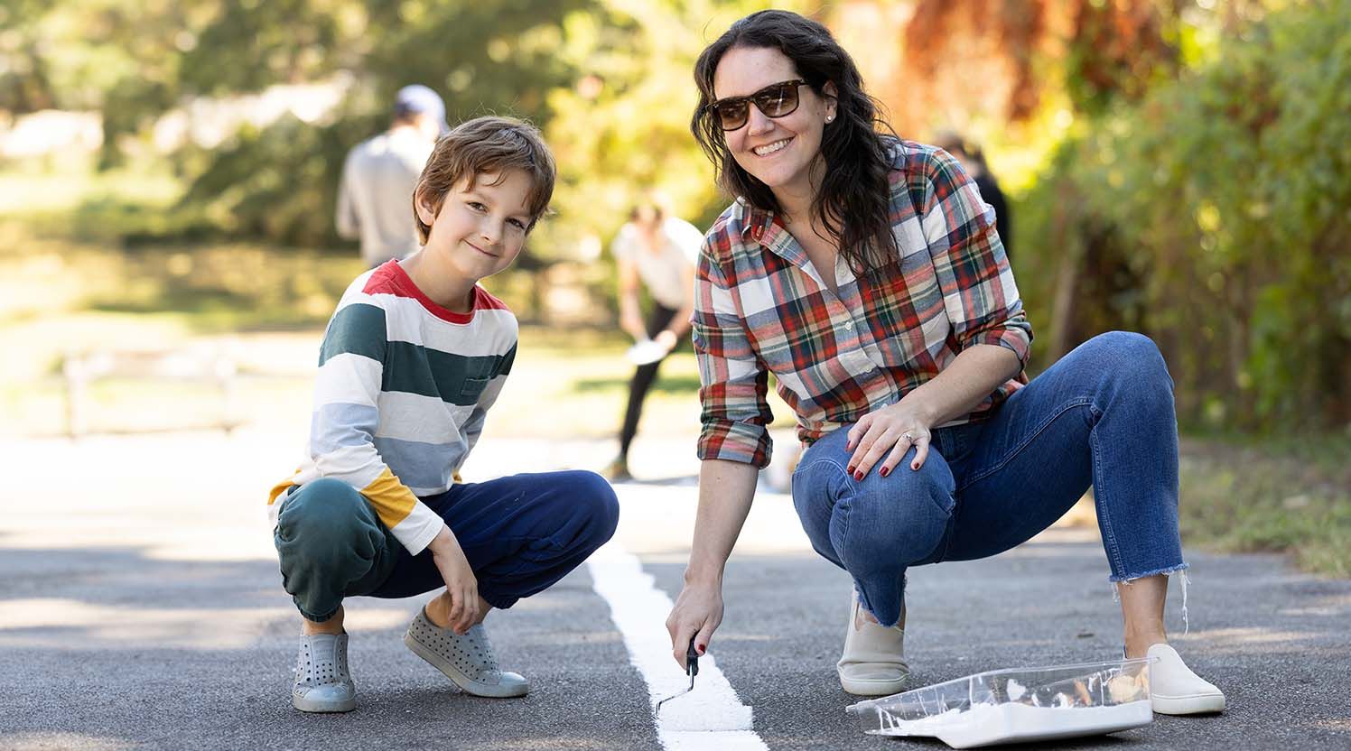 A mom and her son participate in the WoodmenLife school clean up project in Little Rock, AR