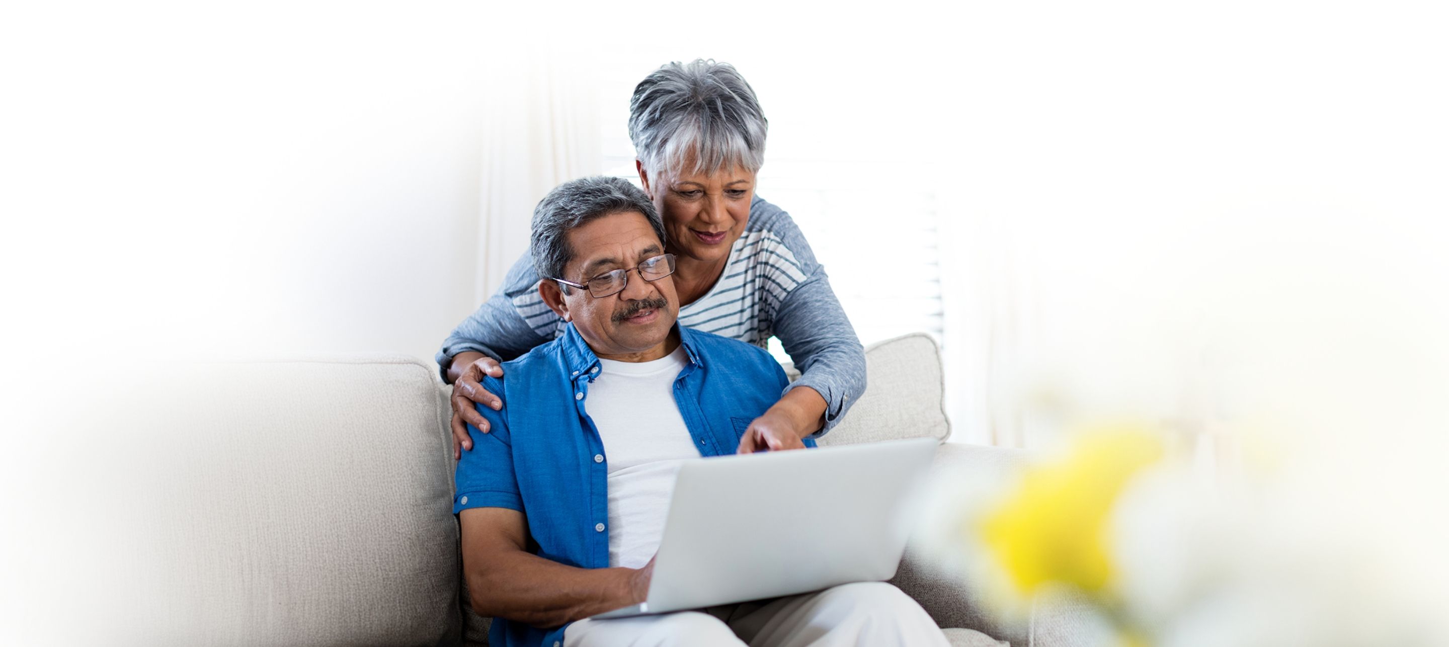 An elderly couple looking at a computer