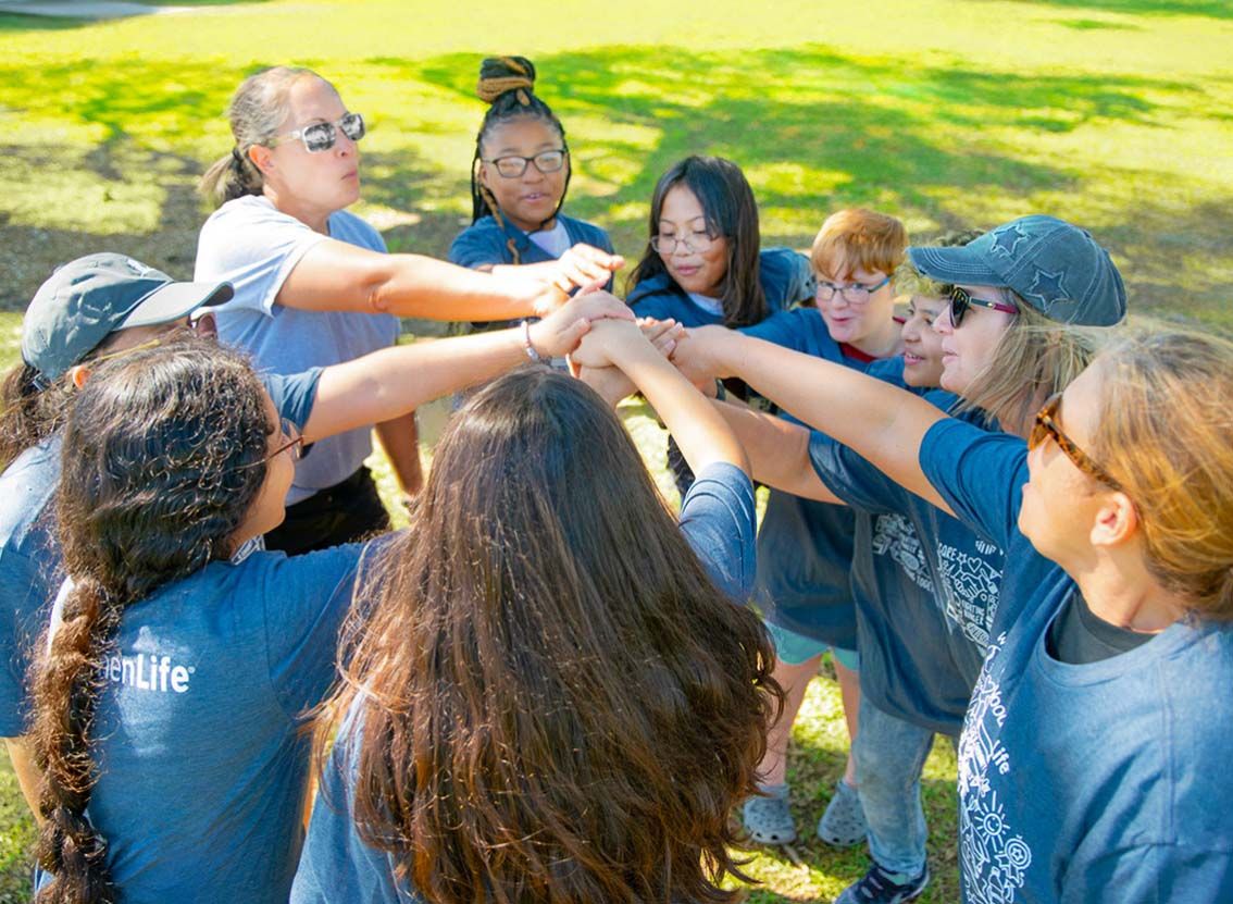 A group of young WoodmenLife volunteers huddles together
