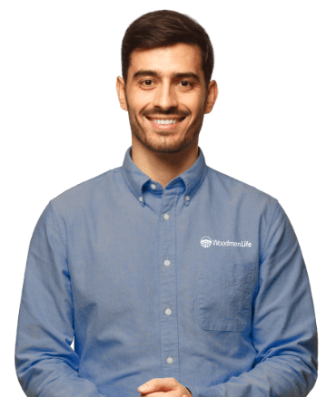 A man in a blue WoodmenLife shirt stands smiling with his hands clasped in front.